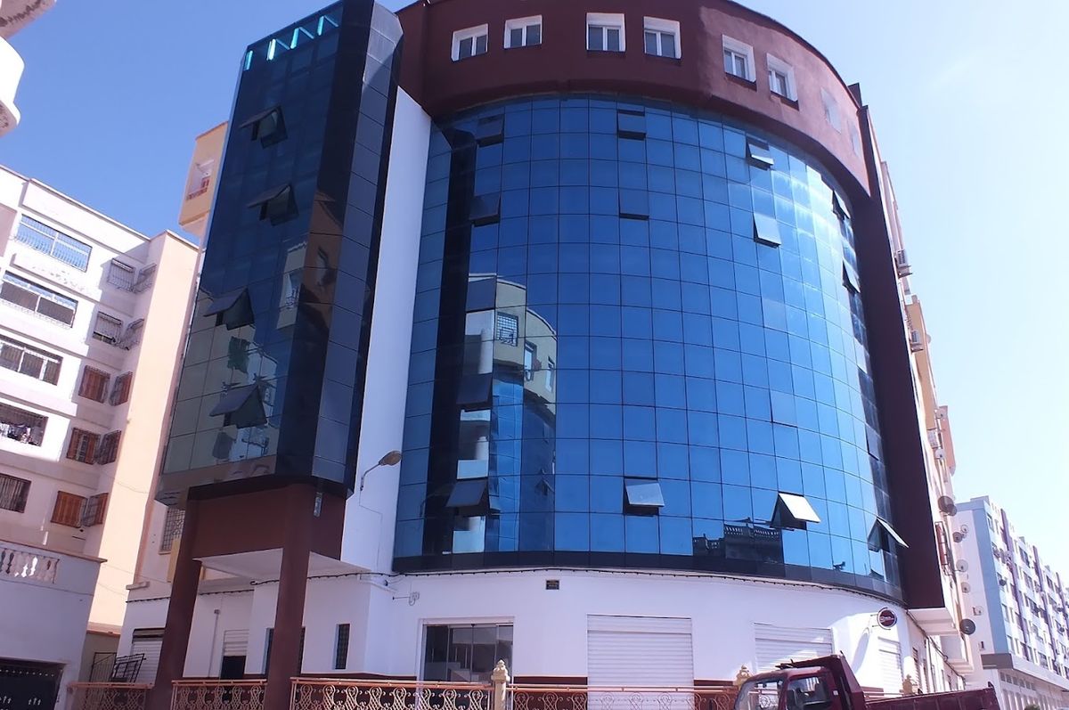 Maza Business Group building in Mostaganem — the blue glass tower hosting Future Skills Lab